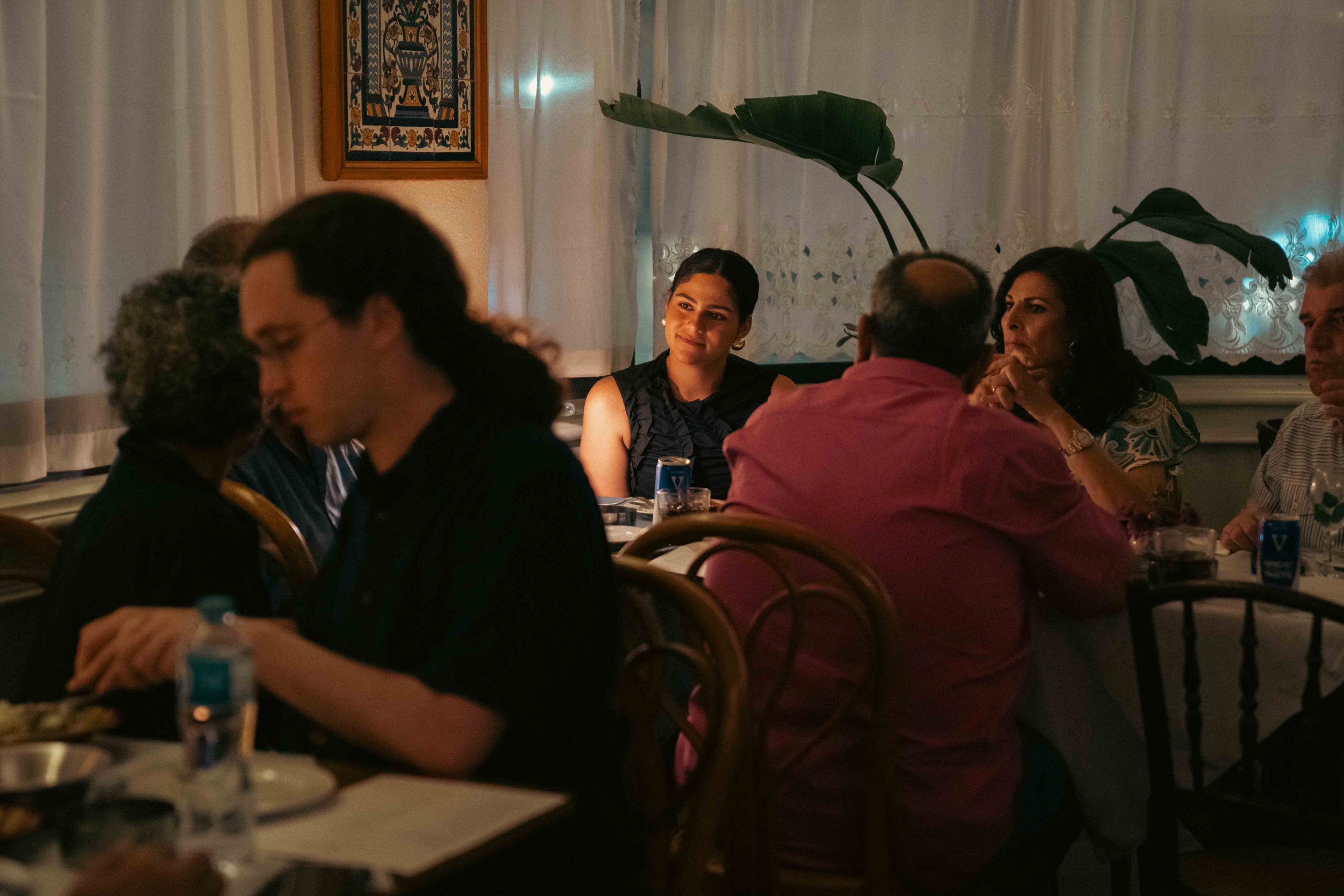 Guests seated beneath a hand-painted tile artwork