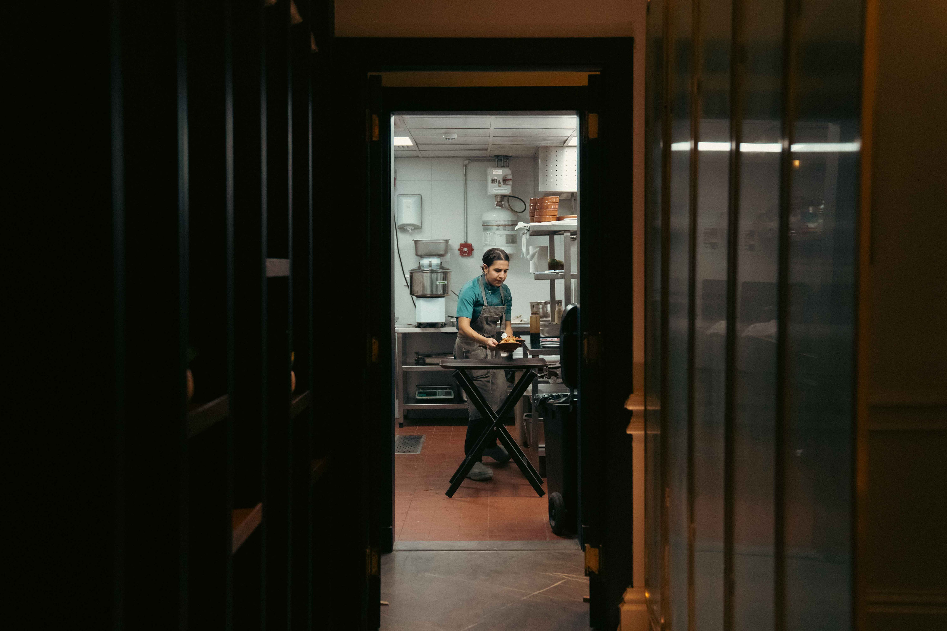 A chef plating a dish in Almería's open kitchen